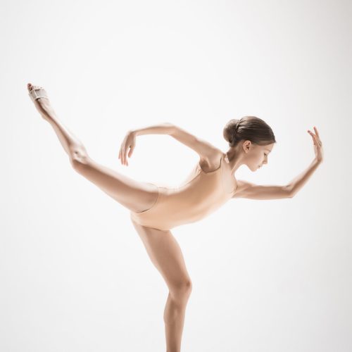 The female teen modern ballet dancer on orange studio background